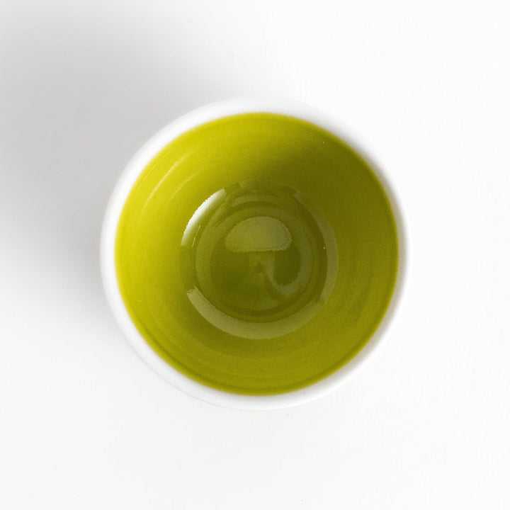 Green Apple Lidded Condiment Bowl, a charming ceramic bowl with a glossy green finish and a small black stem, perfect for serving sauces and condiments.