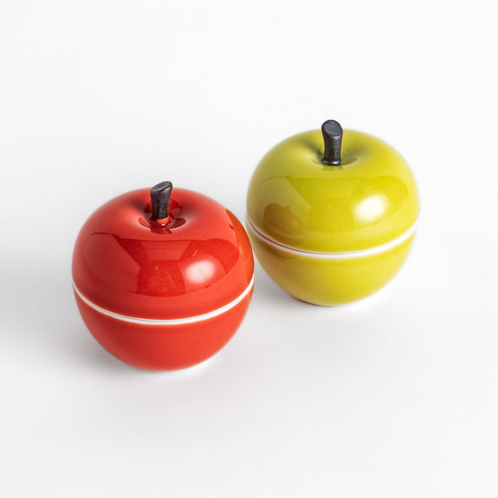 Apple Lidded Condiment Bowls in red and green, charming ceramic pieces with glossy finishes and small black stems, perfect for serving sauces and condiments.