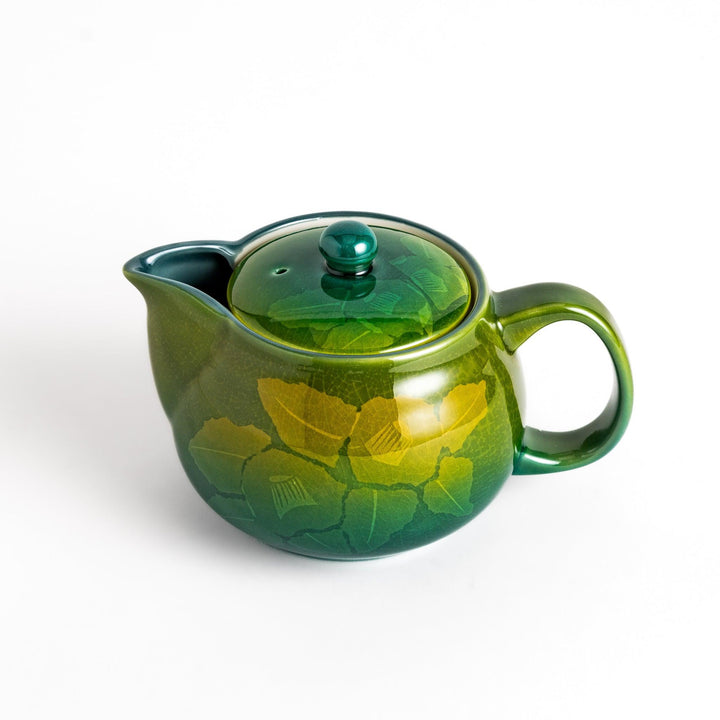 Glossy green ceramic teapot with a subtle leaf pattern, gradient design, and secure lid, perfect for brewing and serving your favorite tea.