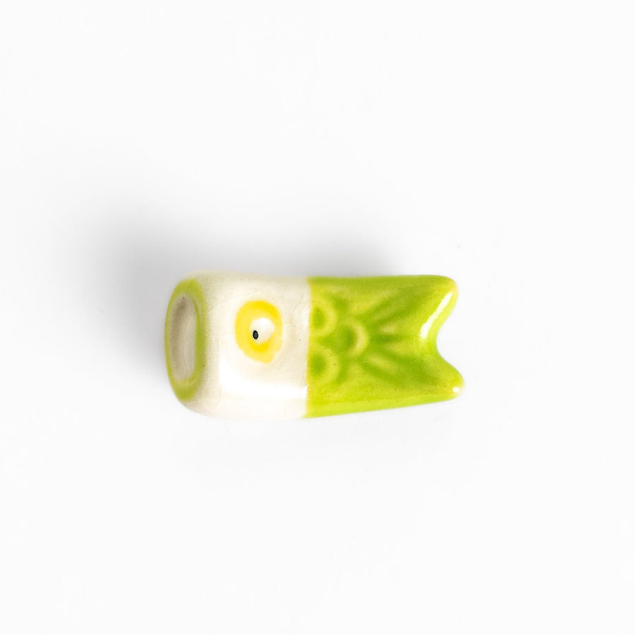 Green carp streamer chopstick rest with a playful yellow eye design.