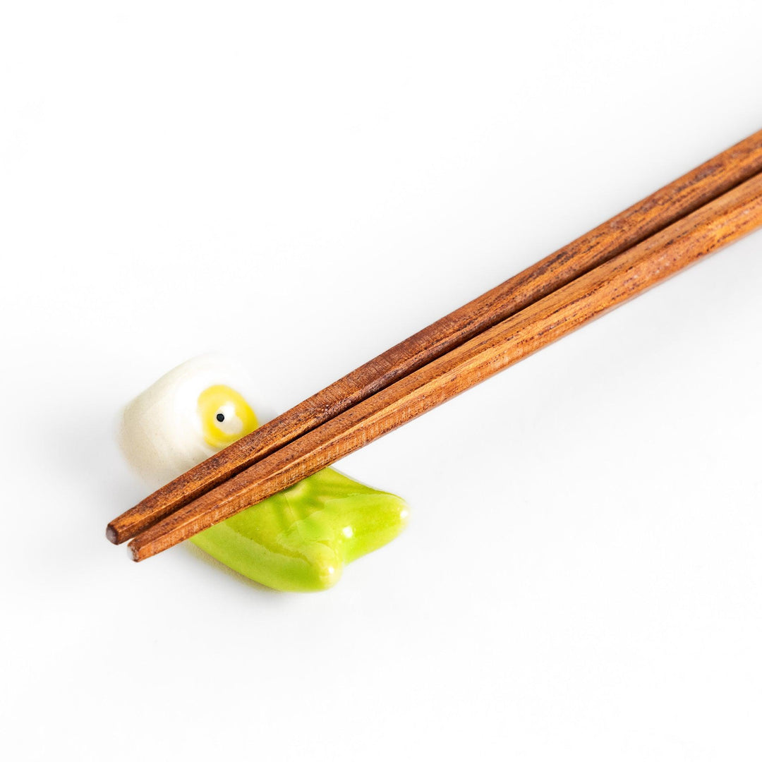 Green carp streamer chopstick rest with a playful yellow eye design.