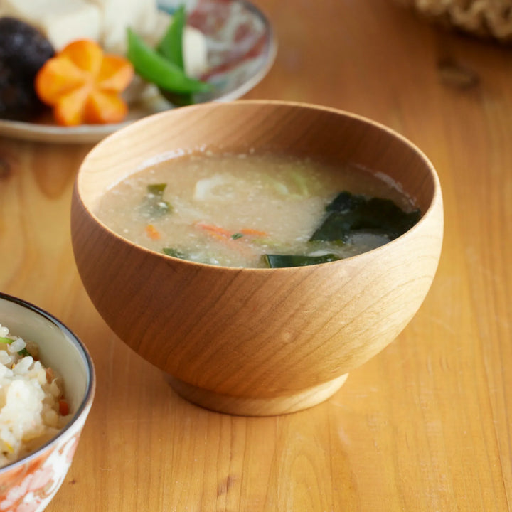 Handcrafted cherry wood medium miso soup bowl filled with miso soup, highlighting the natural grain and warm tone of the wood.