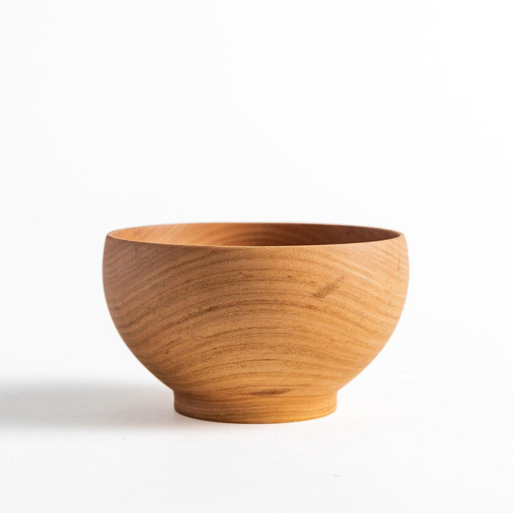 Handcrafted wooden bowl with a smooth finish and gentle curves, perfect for serving soups or snacks.