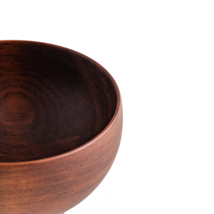 Close-up of the rich brown wooden bowl, highlighting its elegant design and polished finish for stylish dining.