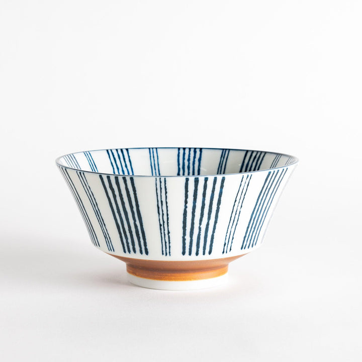 Ceramic ramen bowl with blue striped pattern on white background.