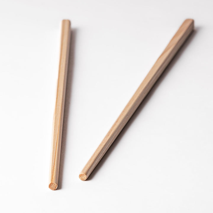 Pair of hinoki wood cooking chopsticks with smooth light wood grain and tapered ends, ideal for Japanese cuisine