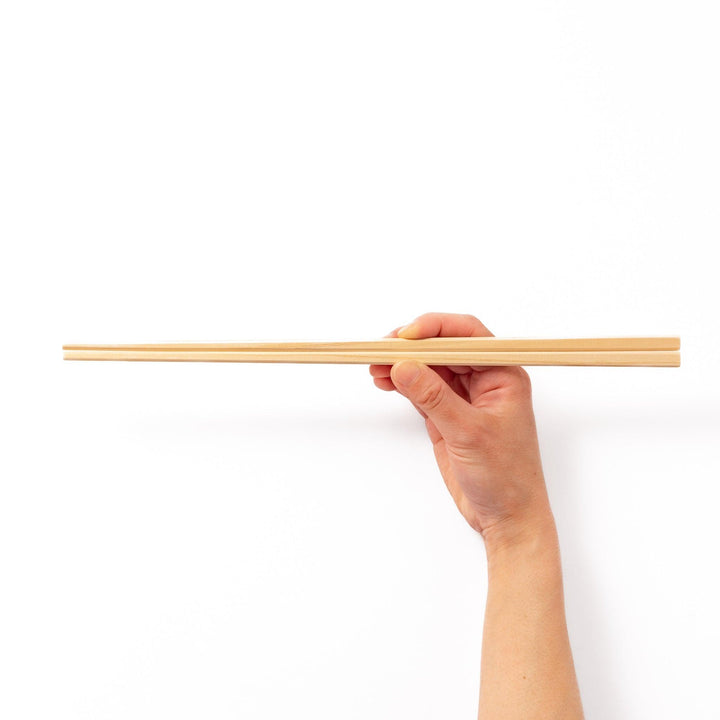 Pair of hinoki wood cooking chopsticks with smooth light wood grain and tapered ends, ideal for Japanese cuisine