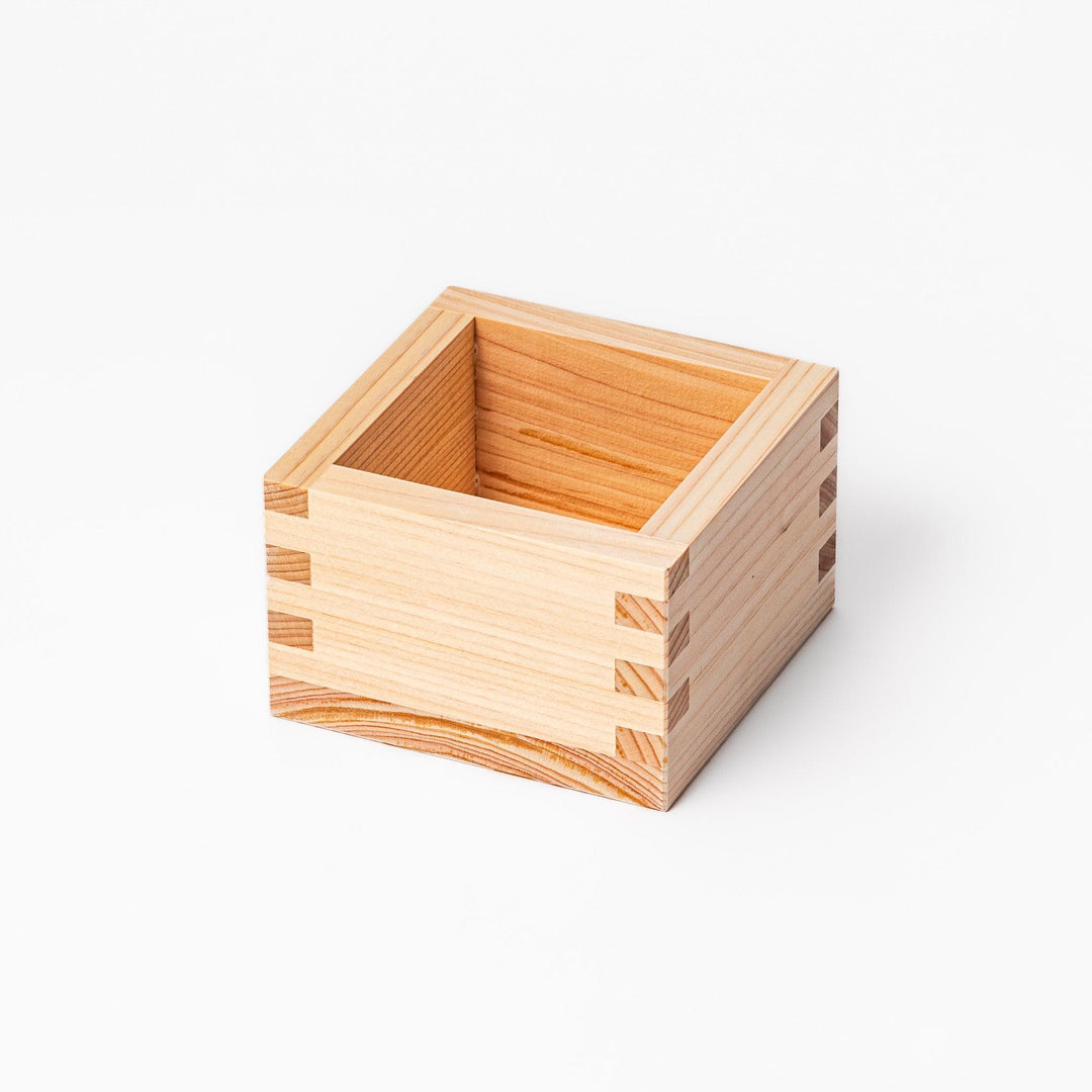 Traditional hinoki wood masu sake cup with visible joinery, offering a natural aroma and authentic way to enjoy Japanese sake or serve condiments.
