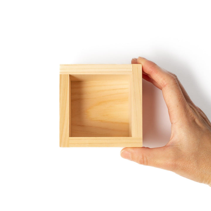 Traditional hinoki wood masu sake cup with visible joinery, offering a natural aroma and authentic way to enjoy Japanese sake or serve condiments.