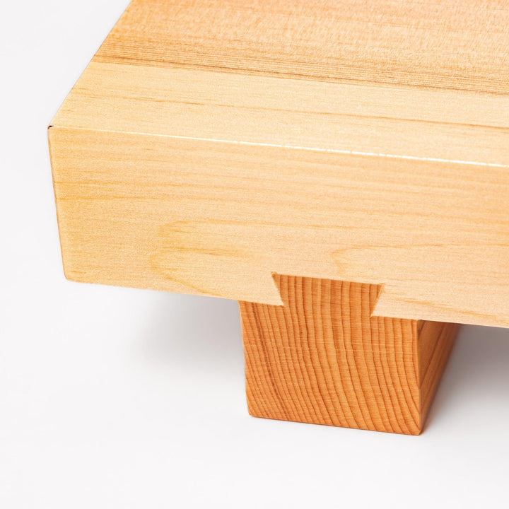 Elevated hinoki wood sushi plate with traditional joinery and natural grain, ideal for presenting sushi or appetizers with refined Japanese style.