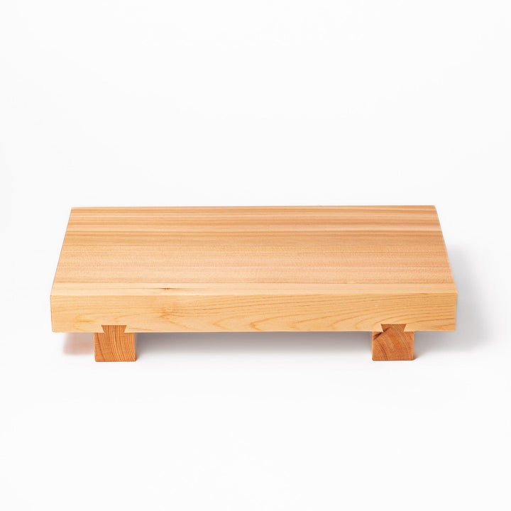 Elevated hinoki wood sushi plate with traditional joinery and natural grain, ideal for presenting sushi or appetizers with refined Japanese style.