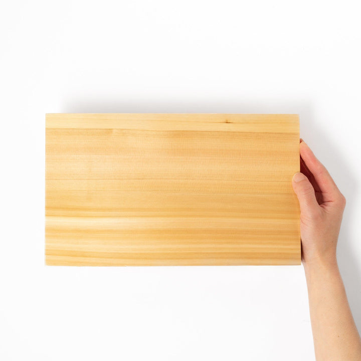 Elevated hinoki wood sushi plate with traditional joinery and natural grain, ideal for presenting sushi or appetizers with refined Japanese style.