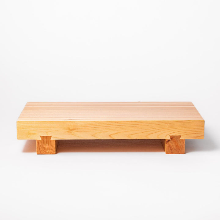 Elevated hinoki wood sushi plate with traditional joinery and natural grain, ideal for presenting sushi or appetizers with refined Japanese style.