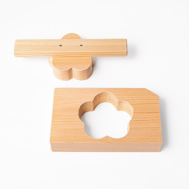 Hinoki wood onigiri mold in a plum blossom shape, ideal for pressing rice into floral forms with a gentle aroma and traditional Japanese charm.