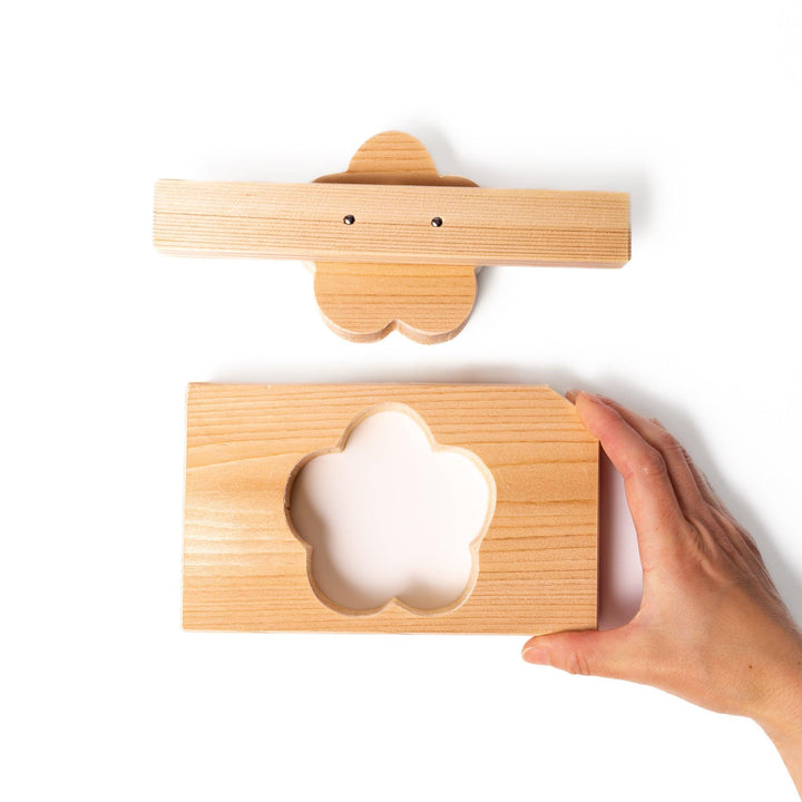 Hinoki wood onigiri mold in a plum blossom shape, ideal for pressing rice into floral forms with a gentle aroma and traditional Japanese charm.