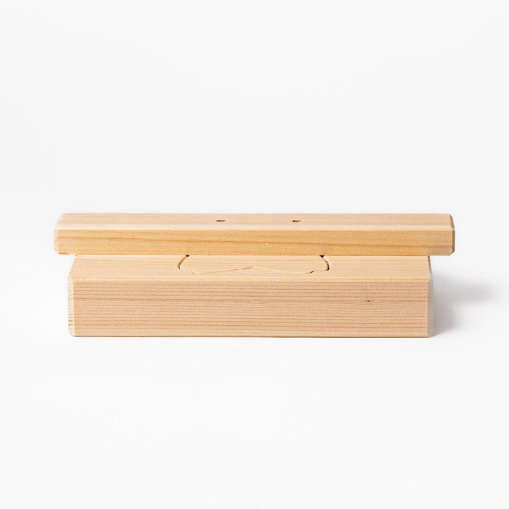 Hinoki wood onigiri mold in a sakura shape, designed for pressing rice into flower forms with a natural aroma and traditional Japanese charm.