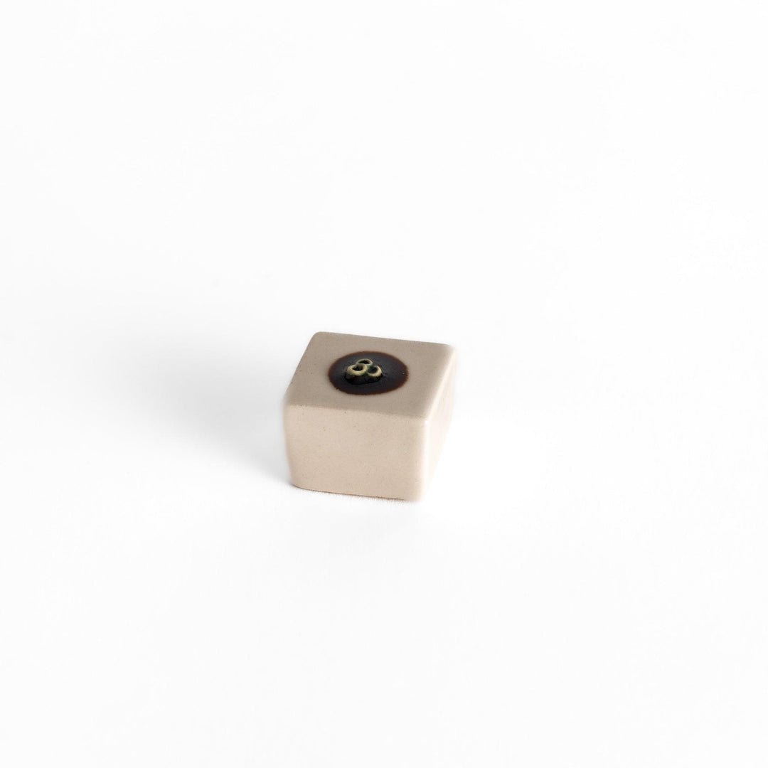 Chopstick rest shaped like a block of hiyayakko tofu, featuring a beige ceramic cube with a decorative circular detail for authenticity.