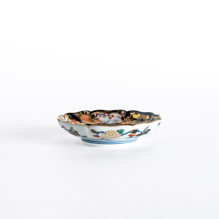 Side view of the Imperial Blossom sauce dish, showcasing the unique shape with gilded edges and detailed floral patterns surrounding the center.