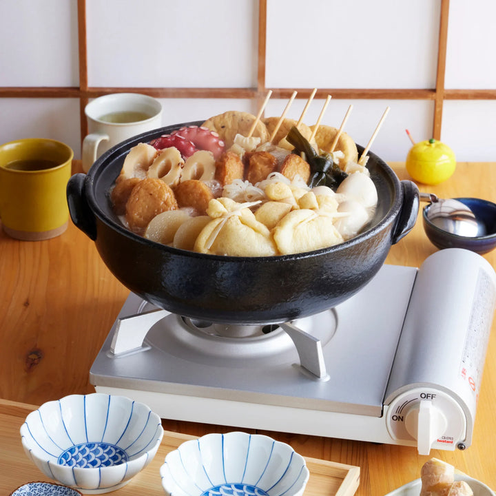 Indigo Floral Family-Size Donabe clay pot simmering Japanese oden with fish cakes, tofu, and vegetables, ideal for shared meals.