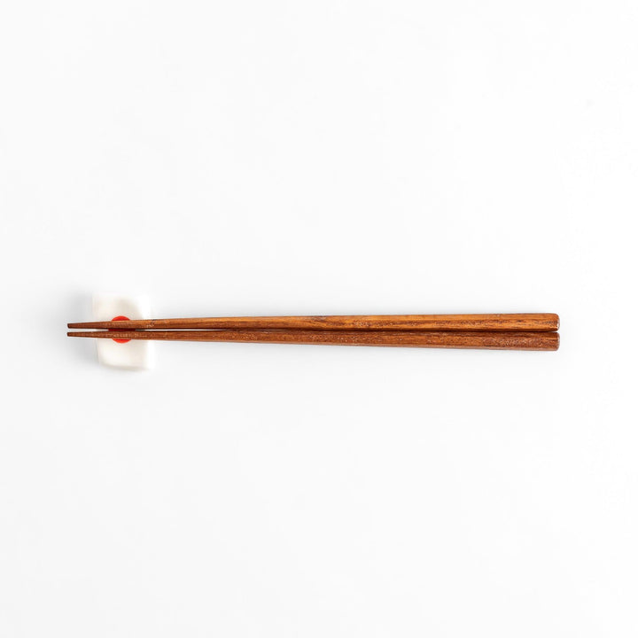 Chopstick rest shaped like the Japanese flag, with a red circle in the center, offering a minimalist and patriotic design.