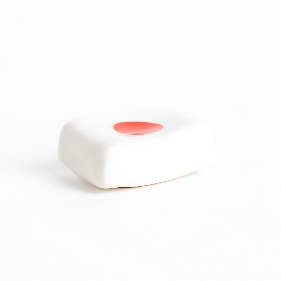 Chopstick rest shaped like the Japanese flag, with a red circle in the center, offering a minimalist and patriotic design.