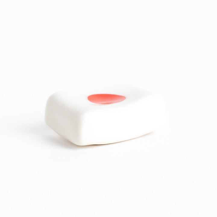 Chopstick rest shaped like the Japanese flag, with a red circle in the center, offering a minimalist and patriotic design.