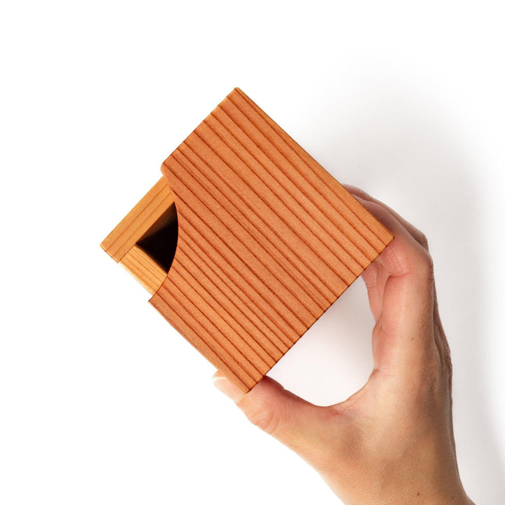 Japanese cedar sake carafe with square lid and visible joinery, combining natural wood texture with traditional craftsmanship for authentic sake service.