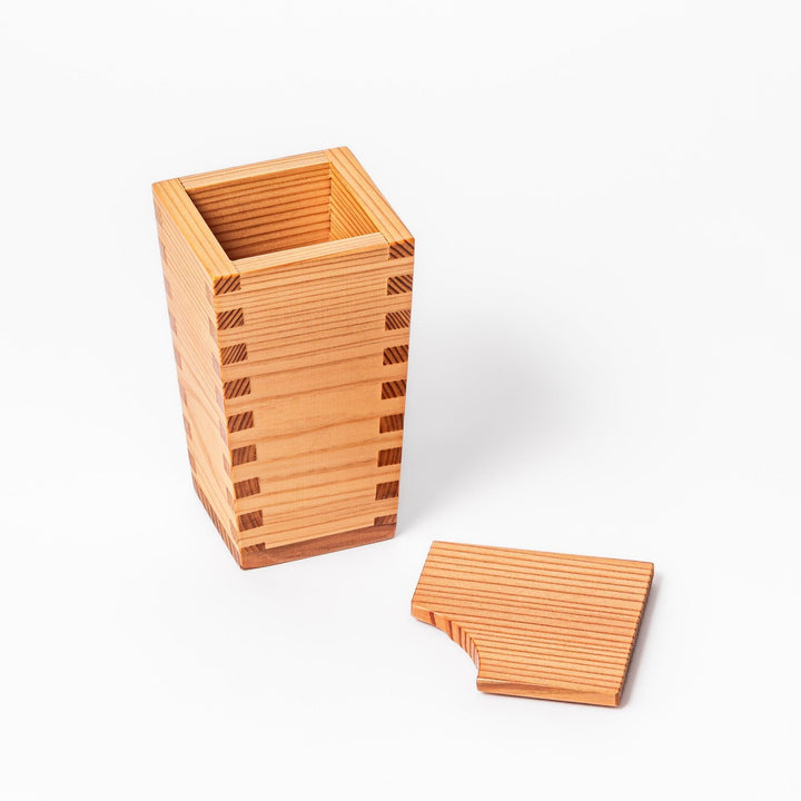 Japanese cedar sake carafe with square lid and visible joinery, combining natural wood texture with traditional craftsmanship for authentic sake service.