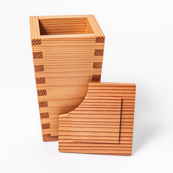 Japanese cedar sake carafe with square lid and visible joinery, combining natural wood texture with traditional craftsmanship for authentic sake service.