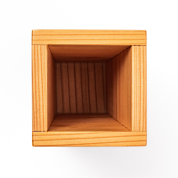 Japanese cedar sake carafe with square lid and visible joinery, combining natural wood texture with traditional craftsmanship for authentic sake service.