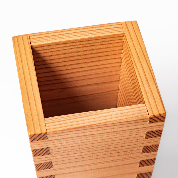 Japanese cedar sake carafe with square lid and visible joinery, combining natural wood texture with traditional craftsmanship for authentic sake service.