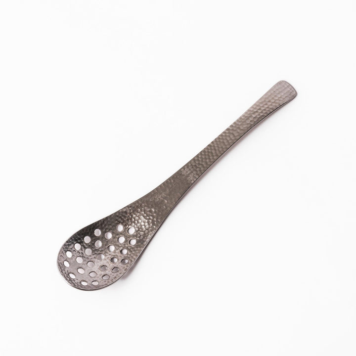 Handcrafted Japanese hammered straining spoon with perforated bowl, ideal for skimming or serving foods while draining excess liquid.