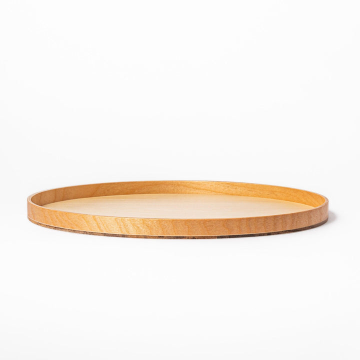Minimalist Japanese round wooden tray with raised edge, crafted from natural wood, perfect for serving tea, snacks, or organizing small items.