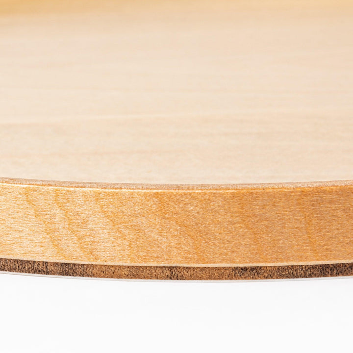 Minimalist Japanese round wooden tray with raised edge, crafted from natural wood, perfect for serving tea, snacks, or organizing small items.