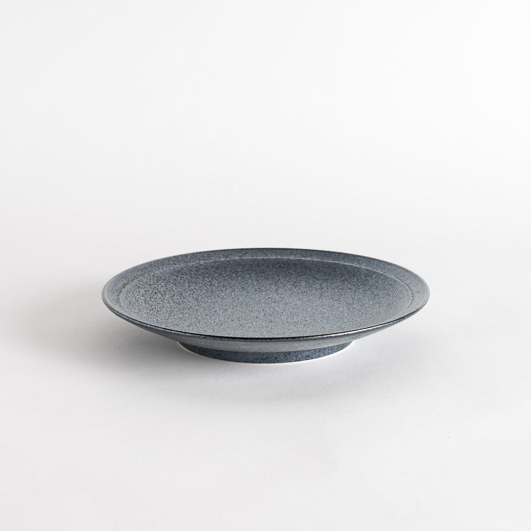 A round black salad plate with a subtle, rustic texture, ideal for modern table settings.