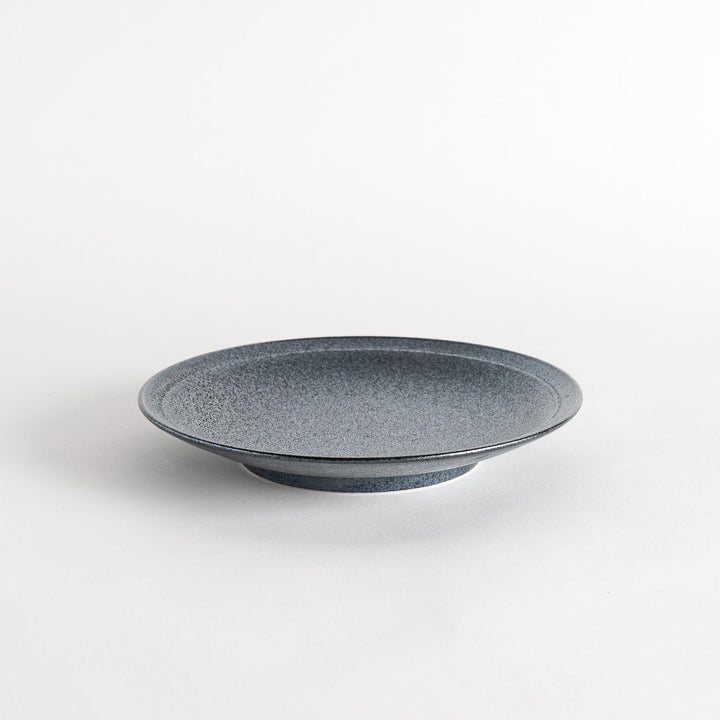 A round black salad plate with a subtle, rustic texture, ideal for modern table settings.