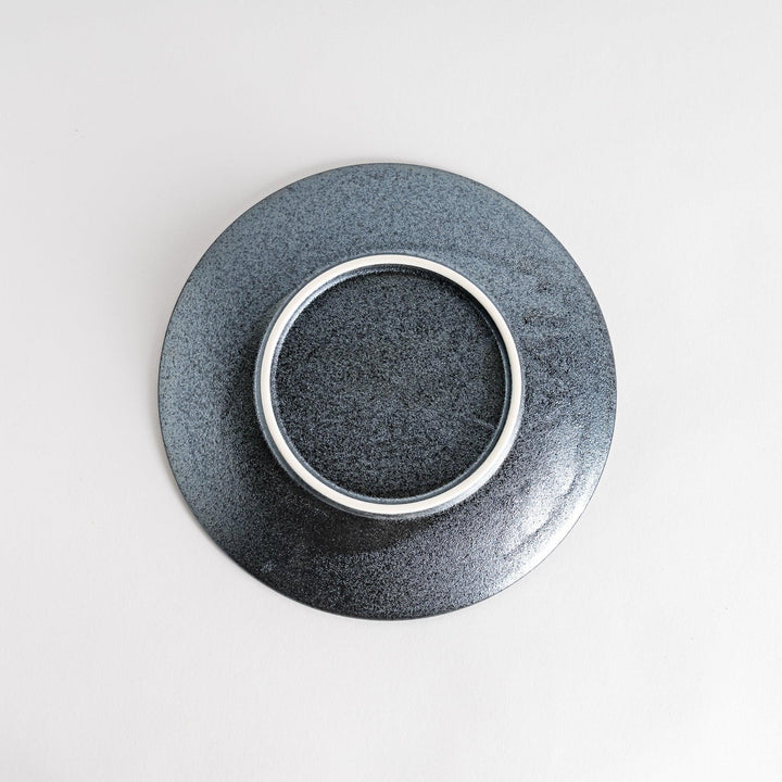 A round black salad plate with a subtle, rustic texture, ideal for modern table settings.