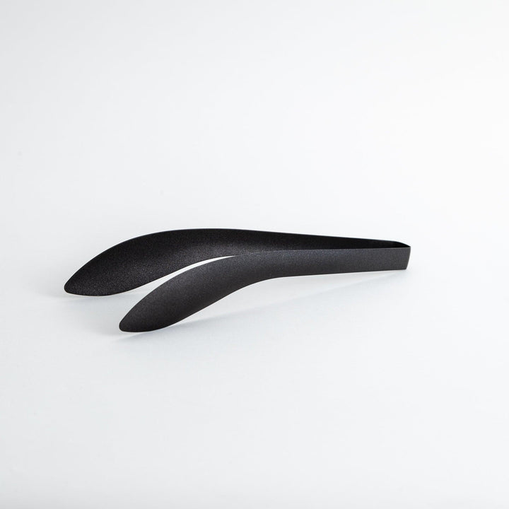 Sleek, matte black serving tongs with smooth curves, ideal for precise handling of small foods.