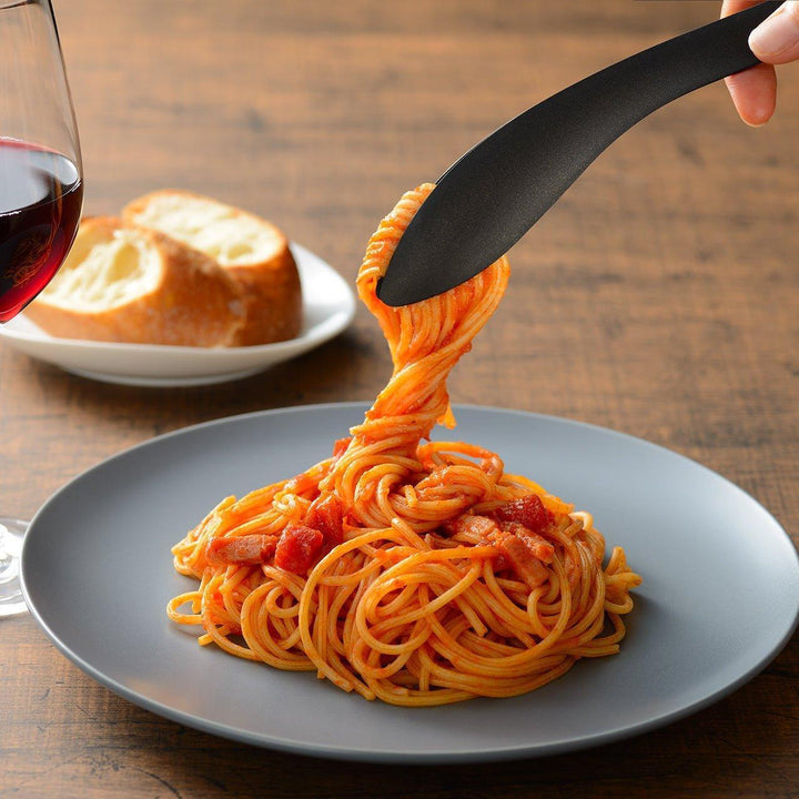 Sleek, matte black serving tongs with smooth curves, ideal for precise handling of small foods.