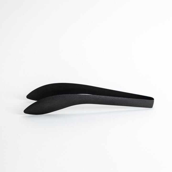 Sleek, matte black serving tongs with smooth curves, ideal for precise handling of small foods.