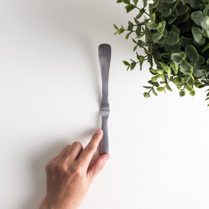 Stainless steel jam spreader with a sleek, double-ended design.