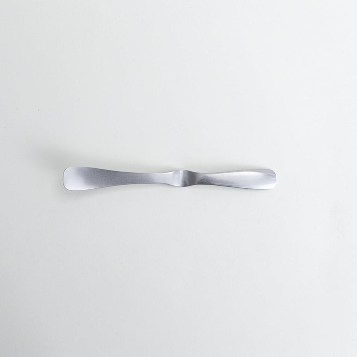 Stainless steel jam spreader with a sleek, double-ended design.