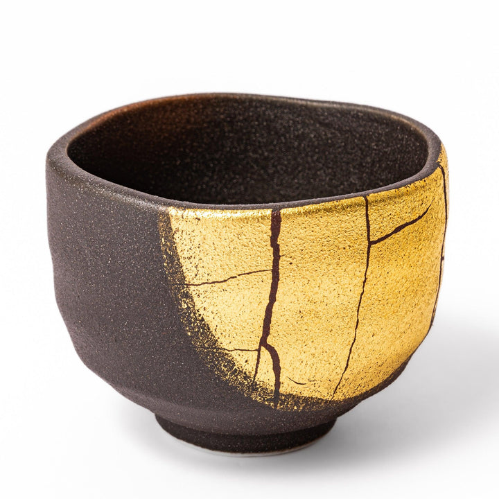 Kintsugi-inspired black Kutani sake cup with bold gold crack design, blending traditional Japanese craftsmanship with contemporary elegance.
