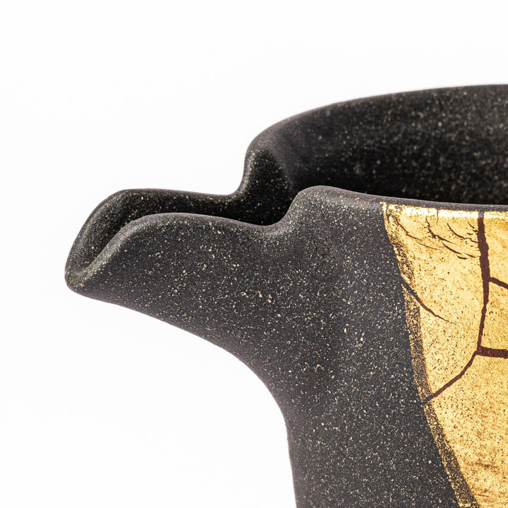 Kintsugi-inspired black Kutani sake carafe with striking gold crackle pattern, showcasing traditional Japanese aesthetics and modern ceramic design.