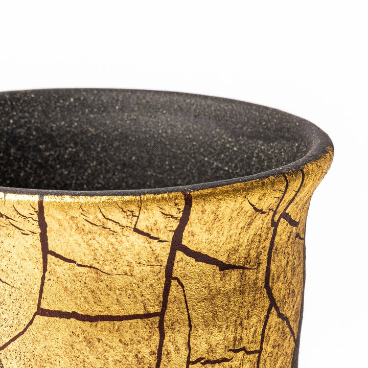 Kintsugi-inspired black Kutani sake carafe with striking gold crackle pattern, showcasing traditional Japanese aesthetics and modern ceramic design.