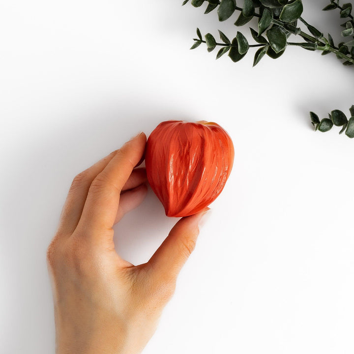 Unique Lantern Plant lidded condiment bowl shaped like a vibrant orange lantern fruit, with intricate details and a smooth, glossy finish, ideal for adding charm to your table setting.
