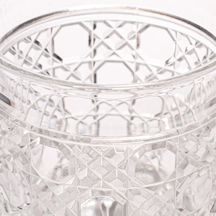 Classic rocks glass with an intricate lattice cut design, perfect for serving whiskey or other spirits with a sophisticated touch.