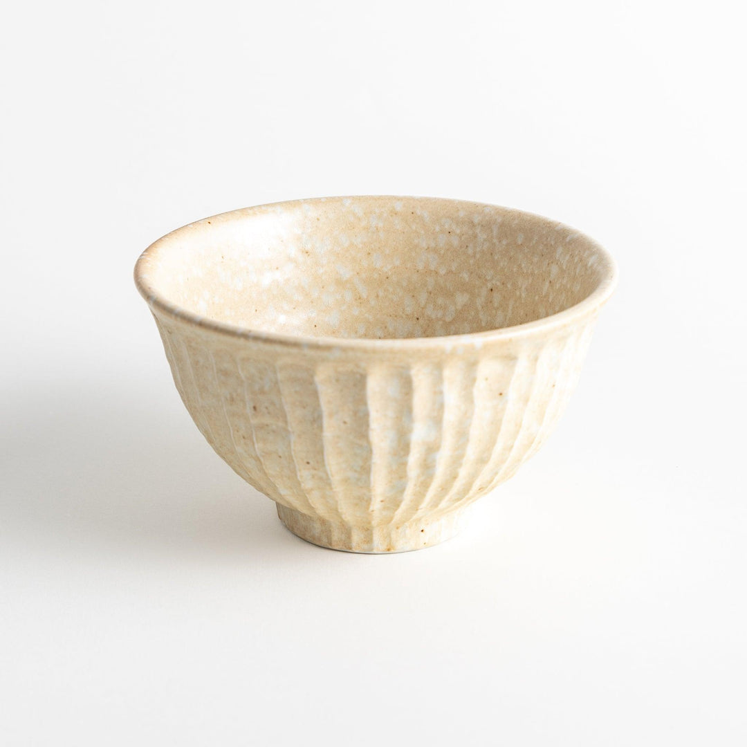 A beige ceramic rice bowl with a natural, rustic texture and a ribbed design.