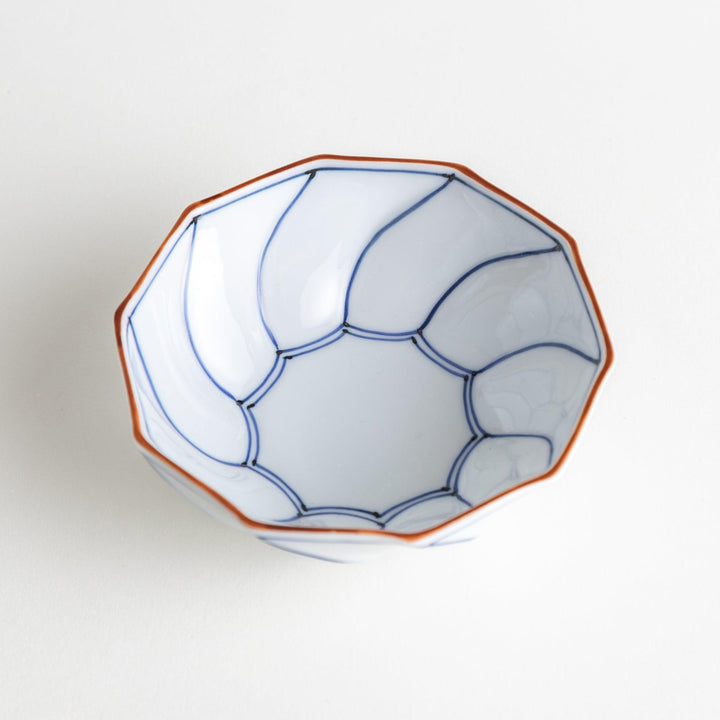 Deep white octagonal dessert bowl with a petal design, outlined in blue or red and finished with a brown rim.