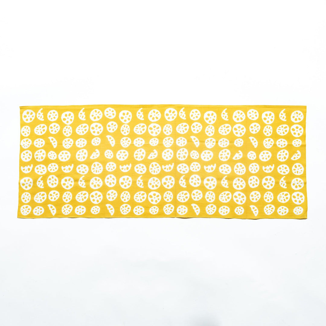 Yellow hand towel showcasing white lotus root slice patterns, fully spread.
